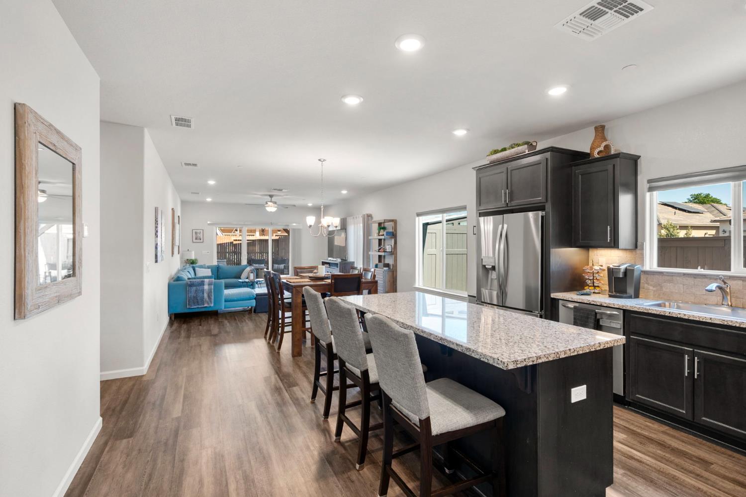 1500 Lahonton Way Ione, CA 95640 - Photo 6 of 52 a kitchen with stainless steel appliances granite countertop a dining table chairs stove refrigerator and cabinets