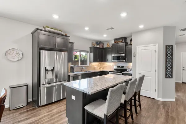 a kitchen with granite countertop a stove and a sink