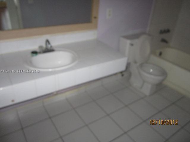 13783 Southwest 66th Street, Unit 219A Miami, FL 33183 - Photo 8 of 10 a bathroom with a sink and a toilet
