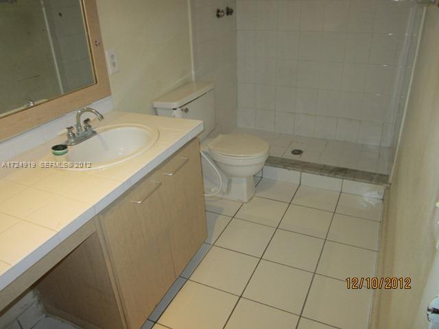 13783 Southwest 66th Street, Unit 219A Miami, FL 33183 - Photo 10 of 10 a bathroom with a sink toilet and shower