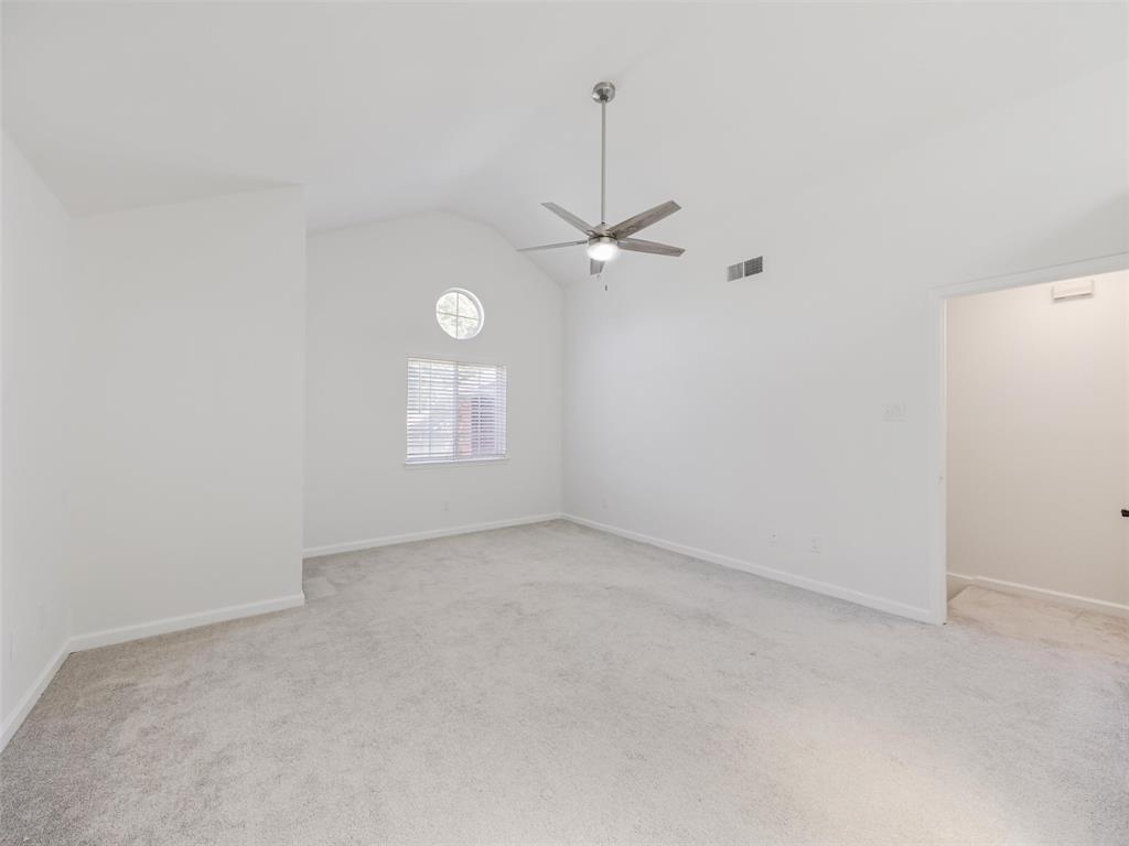 2327 North Ridge Road McKinney, TX 75072 - Photo 18 of 26 Vaulted ceiling featuring a ceiling fan, light gray carpet, and two windows with blinds