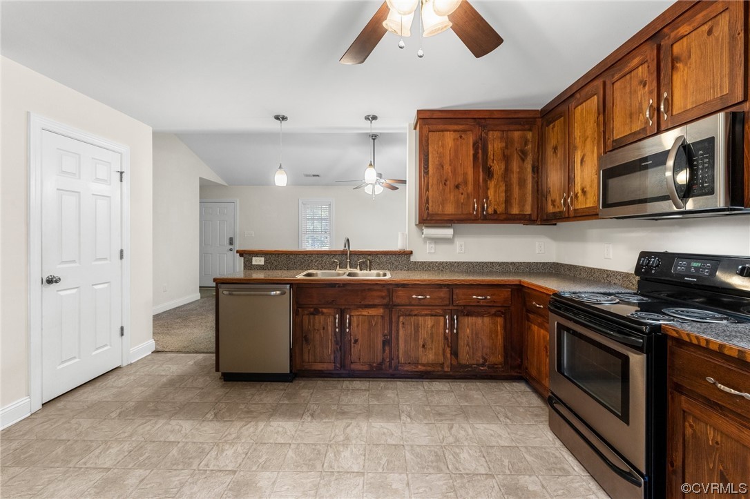 668 East Chinquapin Road King William, VA 23086 - Photo 13 of 21 a kitchen with stainless steel appliances granite countertop a stove a sink and a microwave