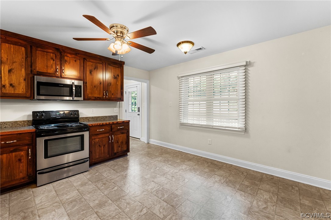 668 East Chinquapin Road King William, VA 23086 - Photo 14 of 21 a kitchen with stainless steel appliances granite countertop a stove sink microwave and refrigerator