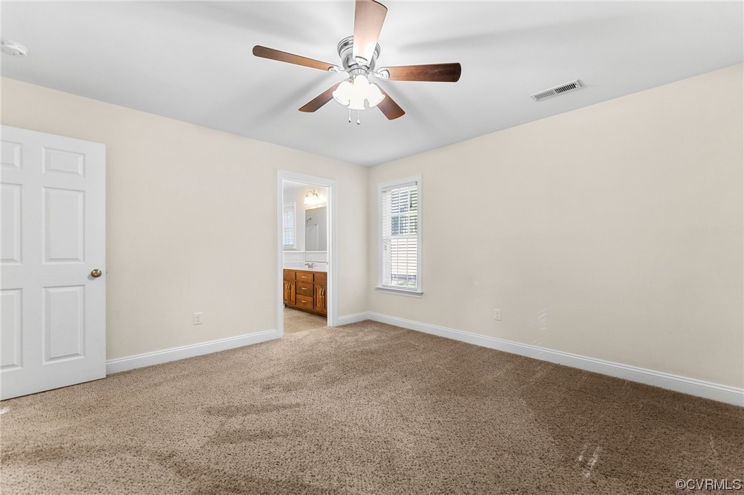 668 East Chinquapin Road King William, VA 23086 - Photo 15 of 21 an empty room with chandelier fan and windows