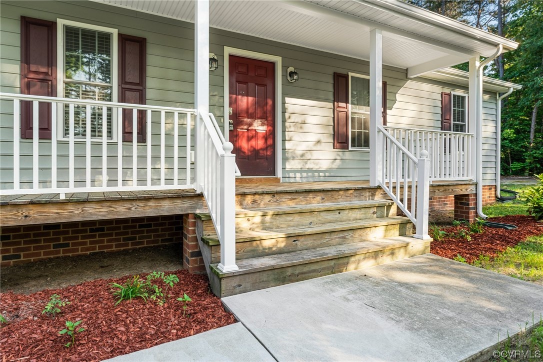 668 East Chinquapin Road King William, VA 23086 - Photo 3 of 21 a front view of a house with a large window and wooden fence