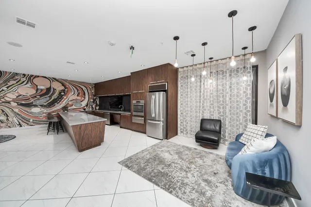 a view of a dining room with furniture and a potted plant