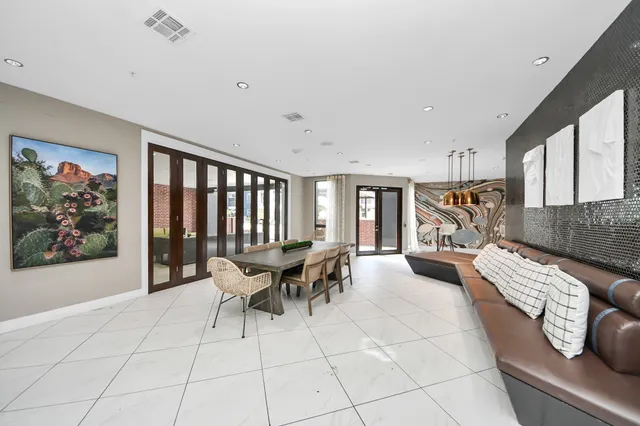 a bedroom with a bed and a lamp on the dresser