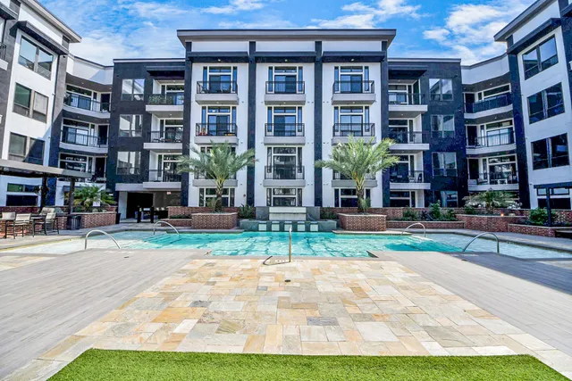 a bedroom with bed and a chandelier
