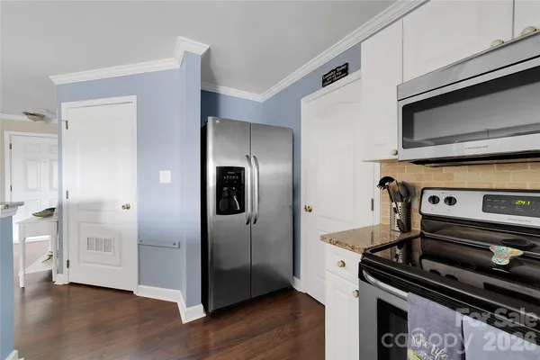 a kitchen with a refrigerator and a stove