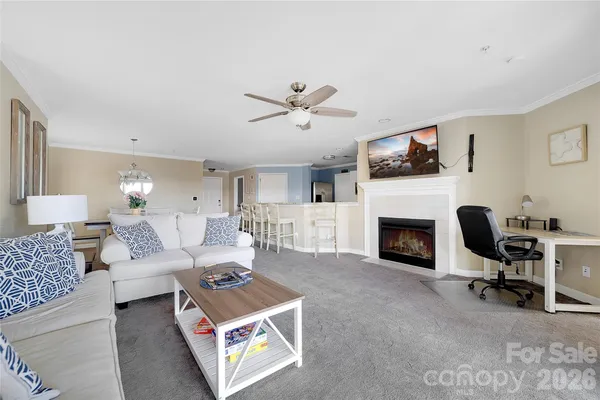 a living room with furniture a fireplace and a flat screen tv