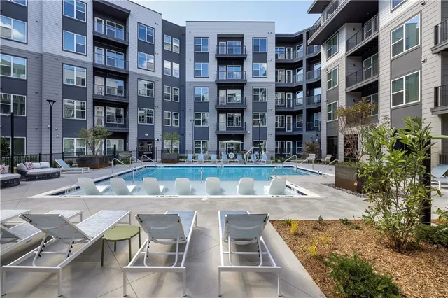 a view of building with swimming pool and sitting space