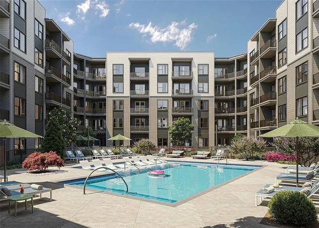 a living room with furniture and kitchen view