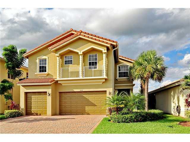 3152 Southwest Porpoise Circle Stuart, FL 34997 - Photo 1 of 19 a front view of a house with a garden