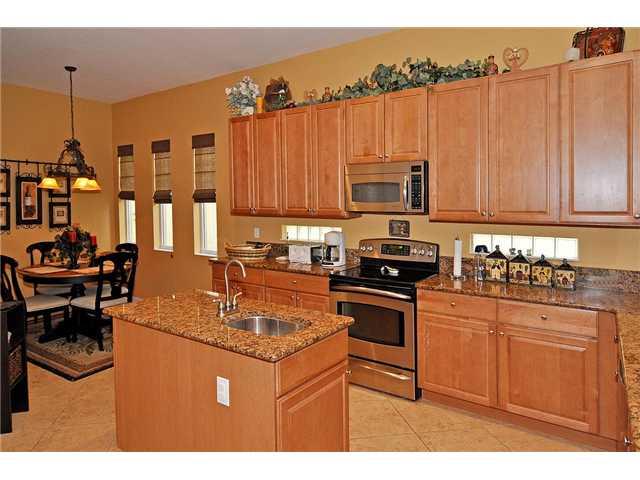 3152 Southwest Porpoise Circle Stuart, FL 34997 - Photo 9 of 19 a kitchen with stainless steel appliances granite countertop a stove a sink and a refrigerator