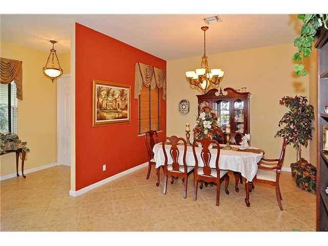 3152 Southwest Porpoise Circle Stuart, FL 34997 - Photo 12 of 19 a dining room dining table chairs and a chandelier