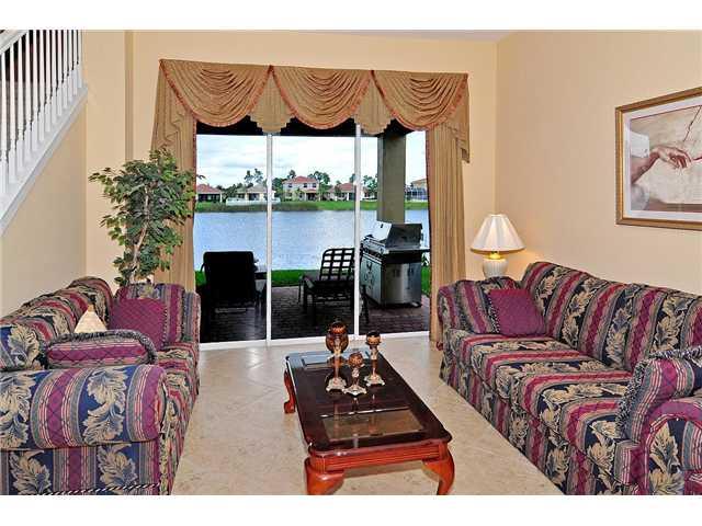 3152 Southwest Porpoise Circle Stuart, FL 34997 - Photo 18 of 19 a living room with furniture and a floor to ceiling window