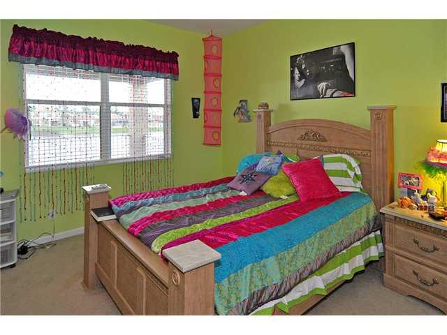 3152 Southwest Porpoise Circle Stuart, FL 34997 - Photo 13 of 19 a bedroom with a bed and window