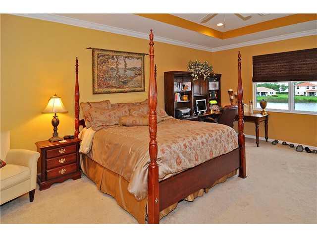 3152 Southwest Porpoise Circle Stuart, FL 34997 - Photo 14 of 19 a bedroom with a bed window and dresser