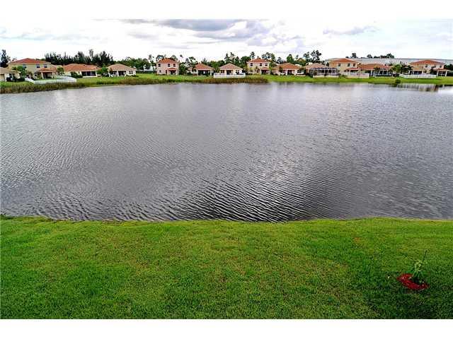 3152 Southwest Porpoise Circle Stuart, FL 34997 - Photo 5 of 19 a view of a lake with houses in the back