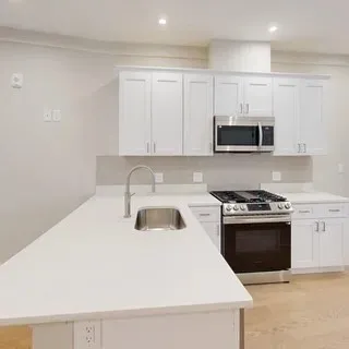 a kitchen with a stove and a microwave