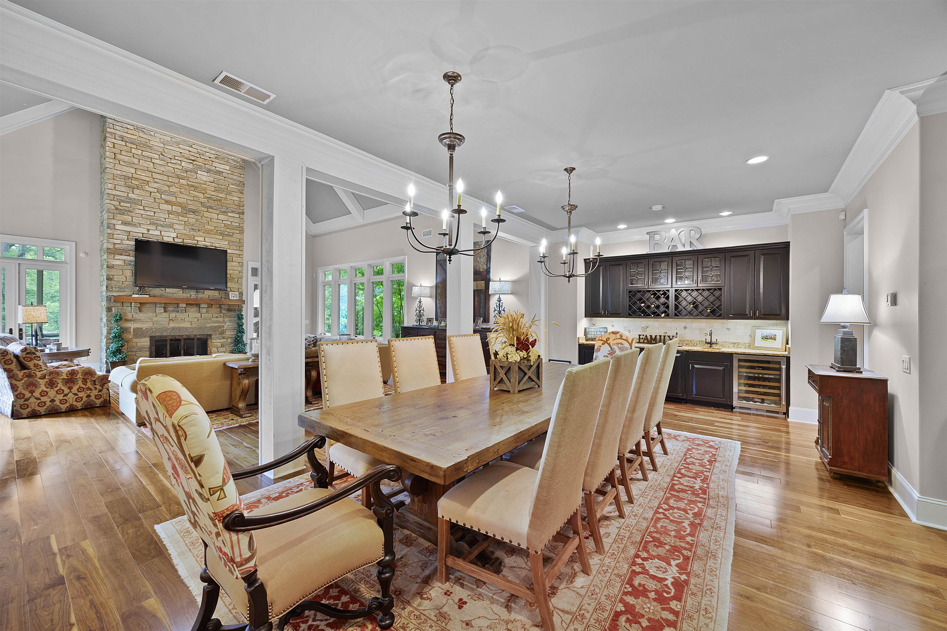 25 Caney Hollow Road Counce, TN 38326 - Photo 9 of 40 Dining space with beverage cooler, bar area, light wood-style floors, crown molding, and a chandelier