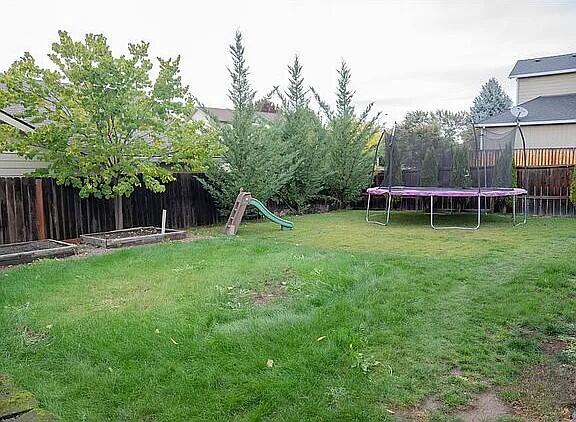 942 Win Way Eagle Point, OR 97524 - Photo 32 of 34 a view of a house with a backyard and a slide