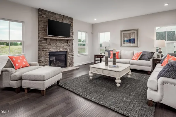 a living room with furniture a rug and a fireplace
