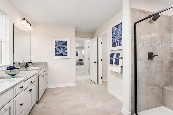 a spacious bathroom with a granite countertop shower sink and mirror