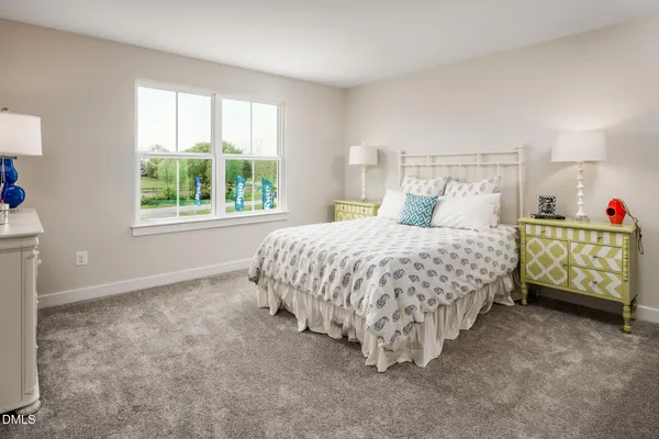 a bedroom with a bed window and a dresser