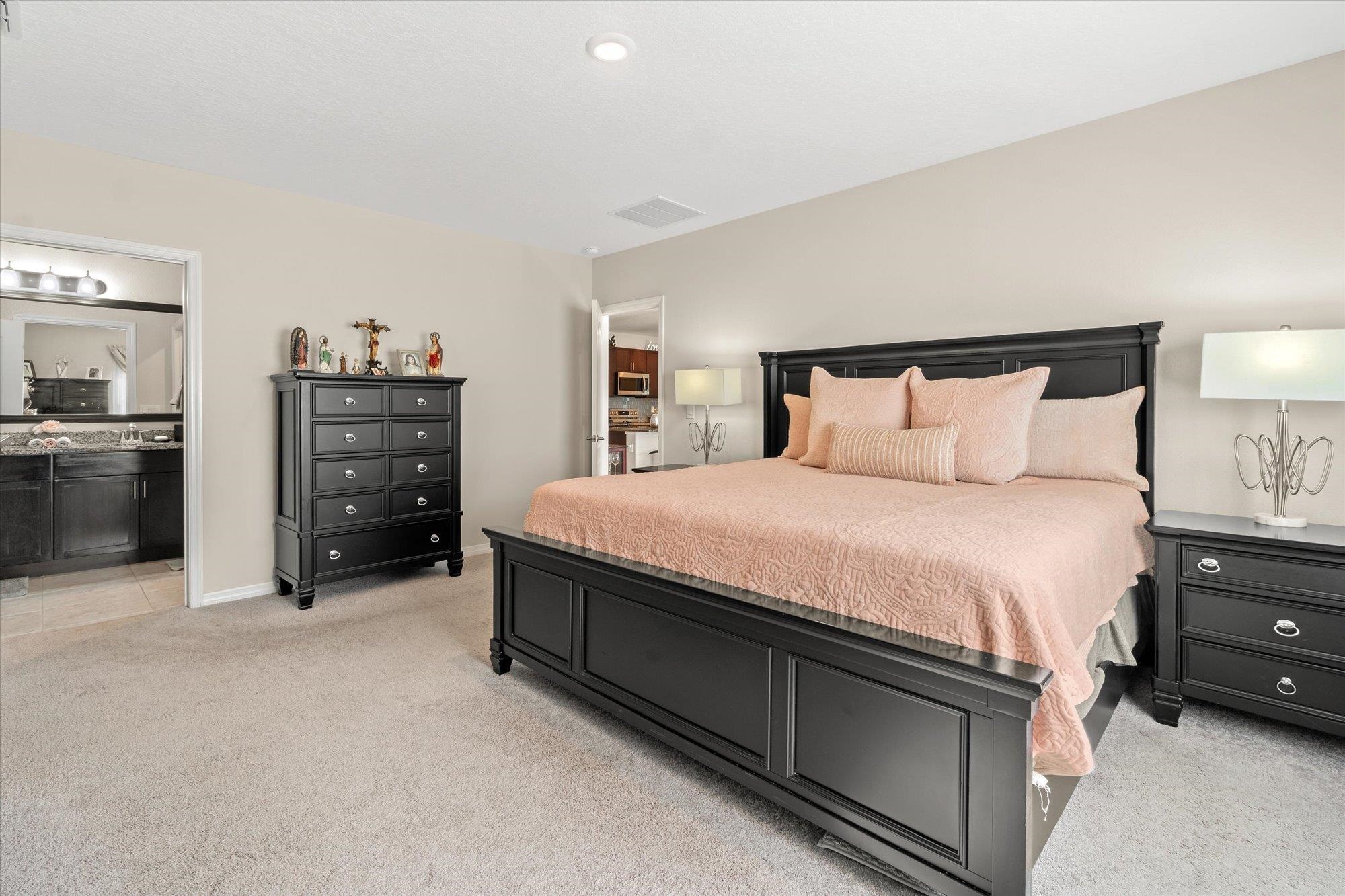 1 Frenora Lane Palm Coast, FL 32137 - Photo 14 of 43 Bedroom featuring light carpet and ensuite bath