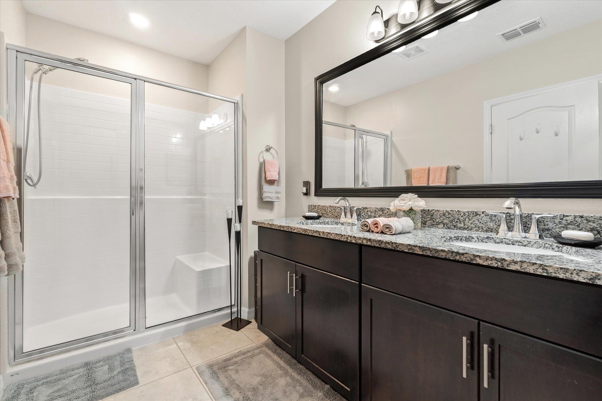 1 Frenora Lane Palm Coast, FL 32137 - Photo 16 of 43 Bathroom with double vanity, a shower stall, recessed lighting, and light tile patterned floors