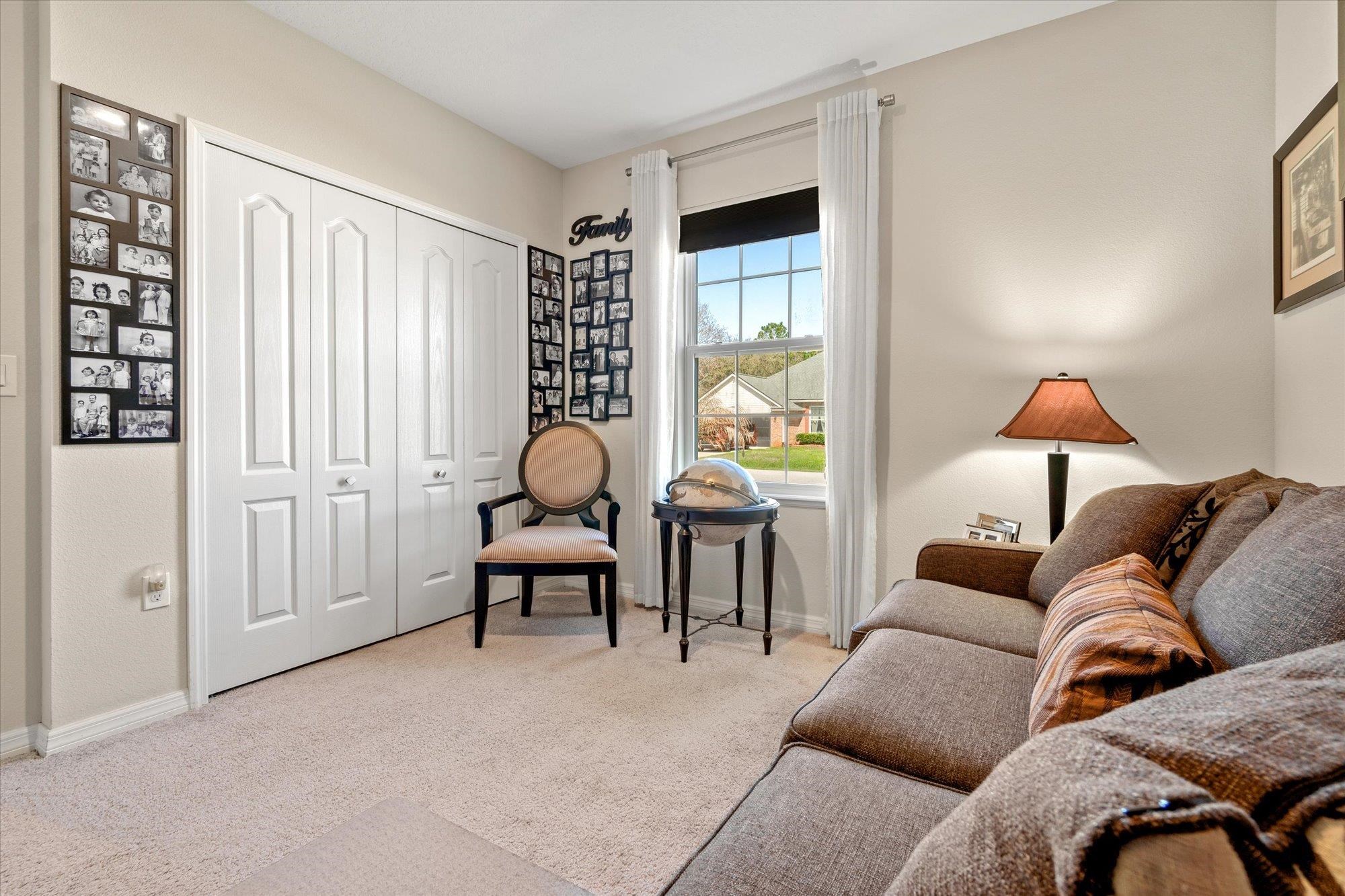 1 Frenora Lane Palm Coast, FL 32137 - Photo 23 of 43 Living area with light colored carpet and baseboards
