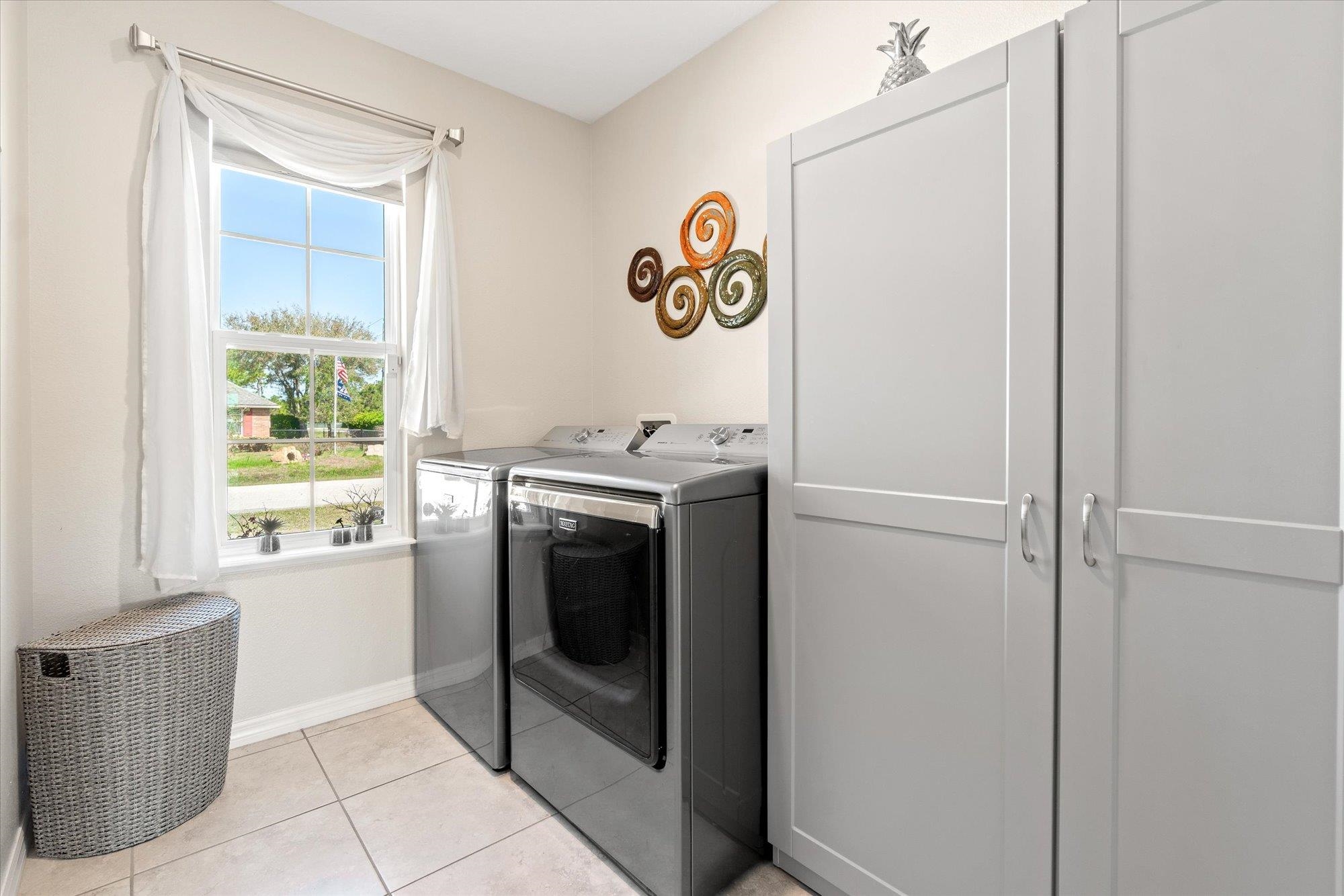 1 Frenora Lane Palm Coast, FL 32137 - Photo 24 of 43 Laundry room featuring independent washer and dryer and light tile patterned floors
