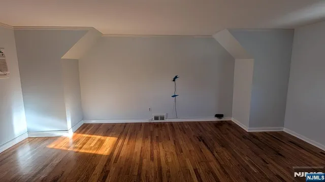 a view of a room with wooden floors and led lights