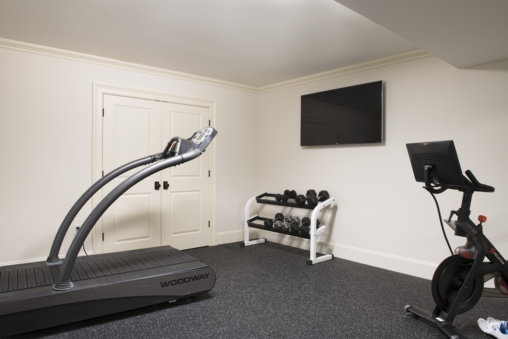 183 Lowell Road Wellesley, MA 02481 - Photo 25 of 27 a room with gym equipment and a flat screen tv