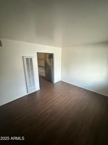 a view of an empty room and wooden floor