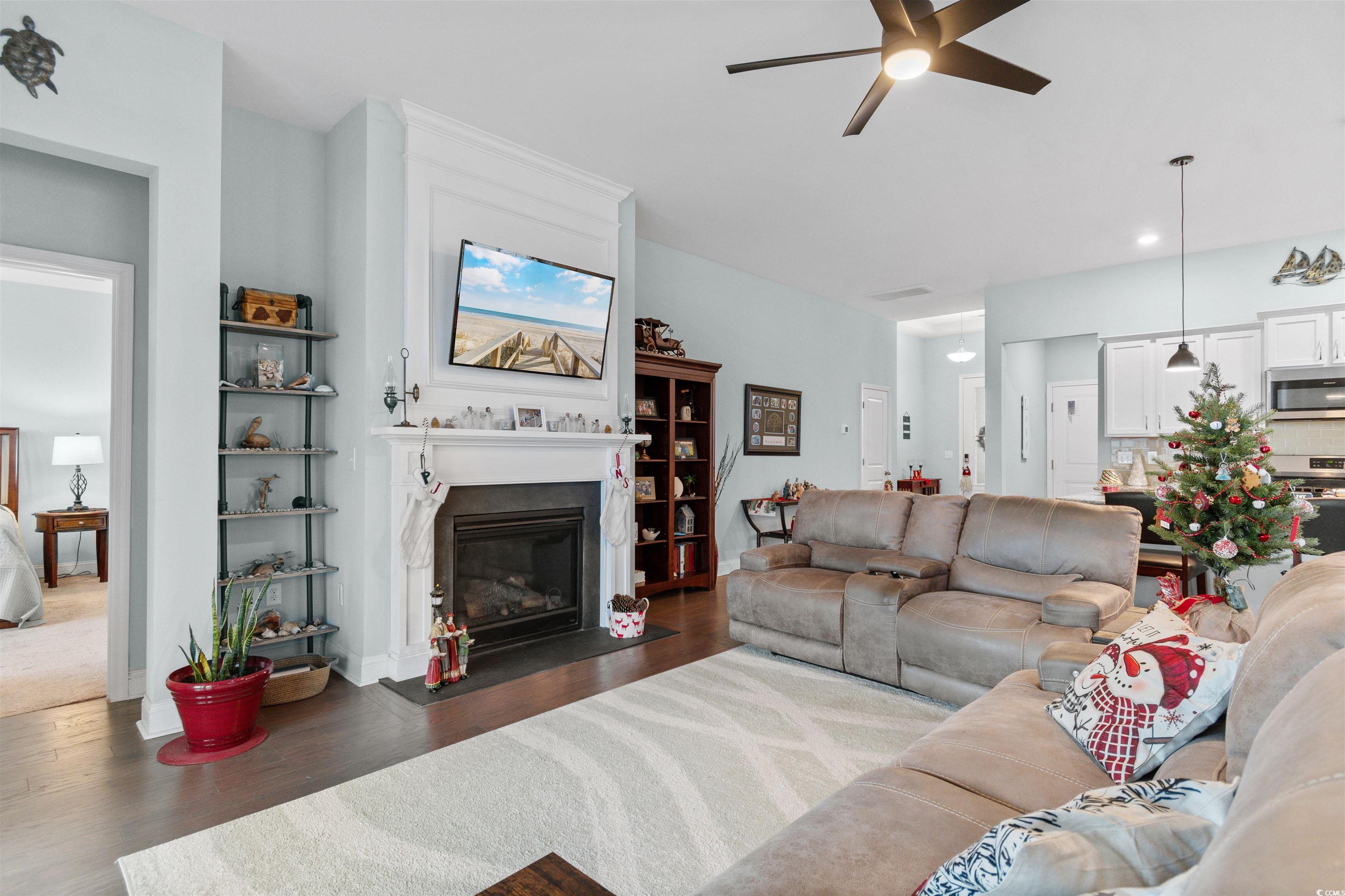 4842 Timberlake Drive Myrtle Beach, SC 29588 - Photo 14 of 38 Living area featuring dark wood-style flooring, a fireplace with flush hearth, ceiling fan, and recessed lighting