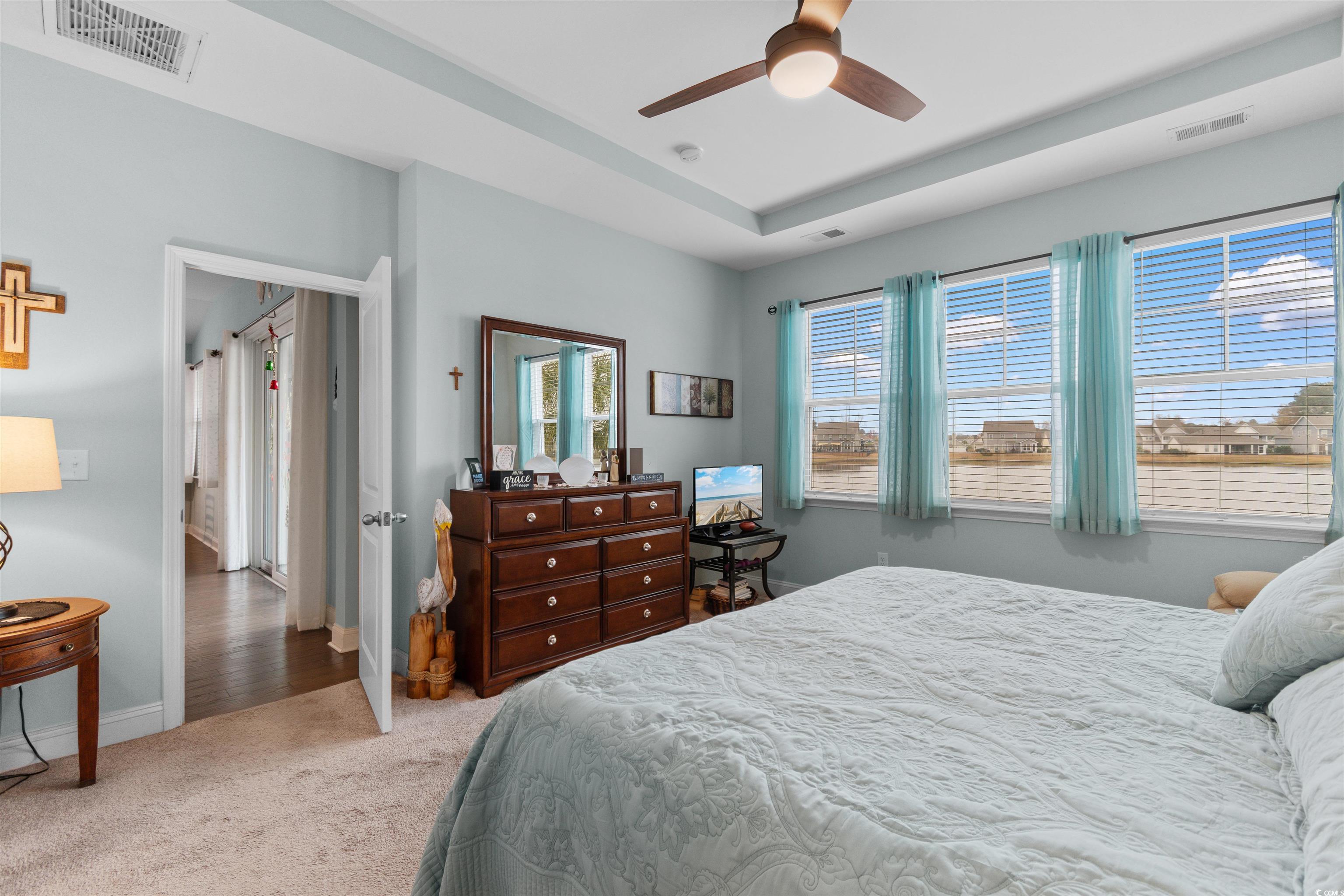 4842 Timberlake Drive Myrtle Beach, SC 29588 - Photo 25 of 38 Bedroom featuring light colored carpet, ceiling fan, and a tray ceiling