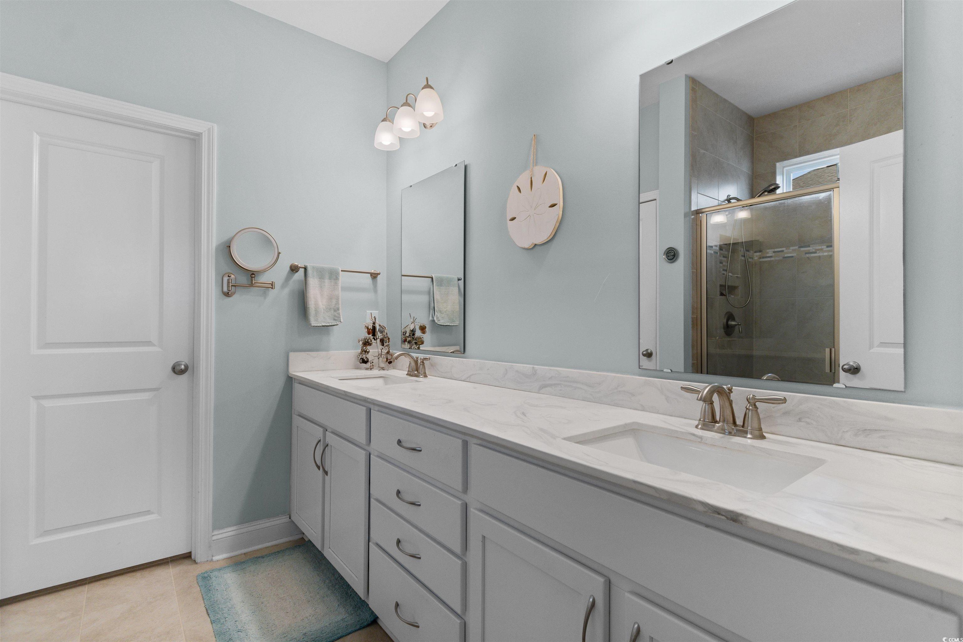 4842 Timberlake Drive Myrtle Beach, SC 29588 - Photo 27 of 38 Bathroom featuring a stall shower, double vanity, and light tile patterned floors