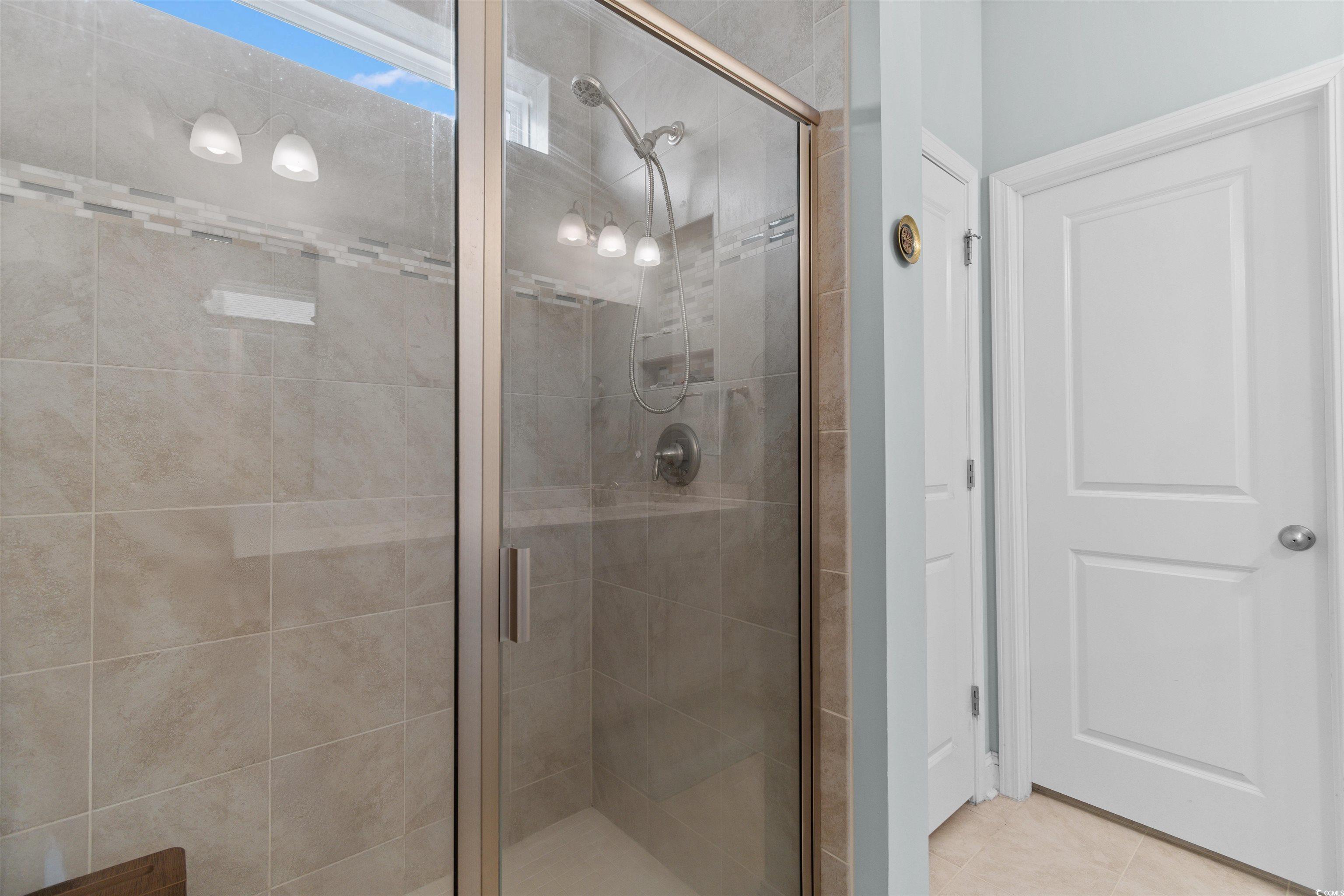 4842 Timberlake Drive Myrtle Beach, SC 29588 - Photo 28 of 38 Full bath with a stall shower and tile patterned floors