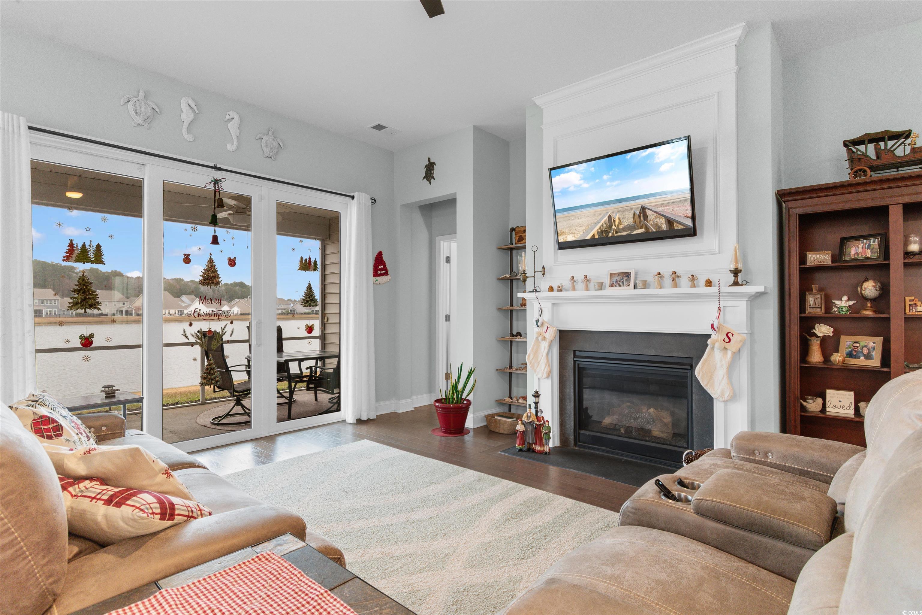 4842 Timberlake Drive Myrtle Beach, SC 29588 - Photo 3 of 38 Living area featuring a fireplace with flush hearth and dark wood-style flooring