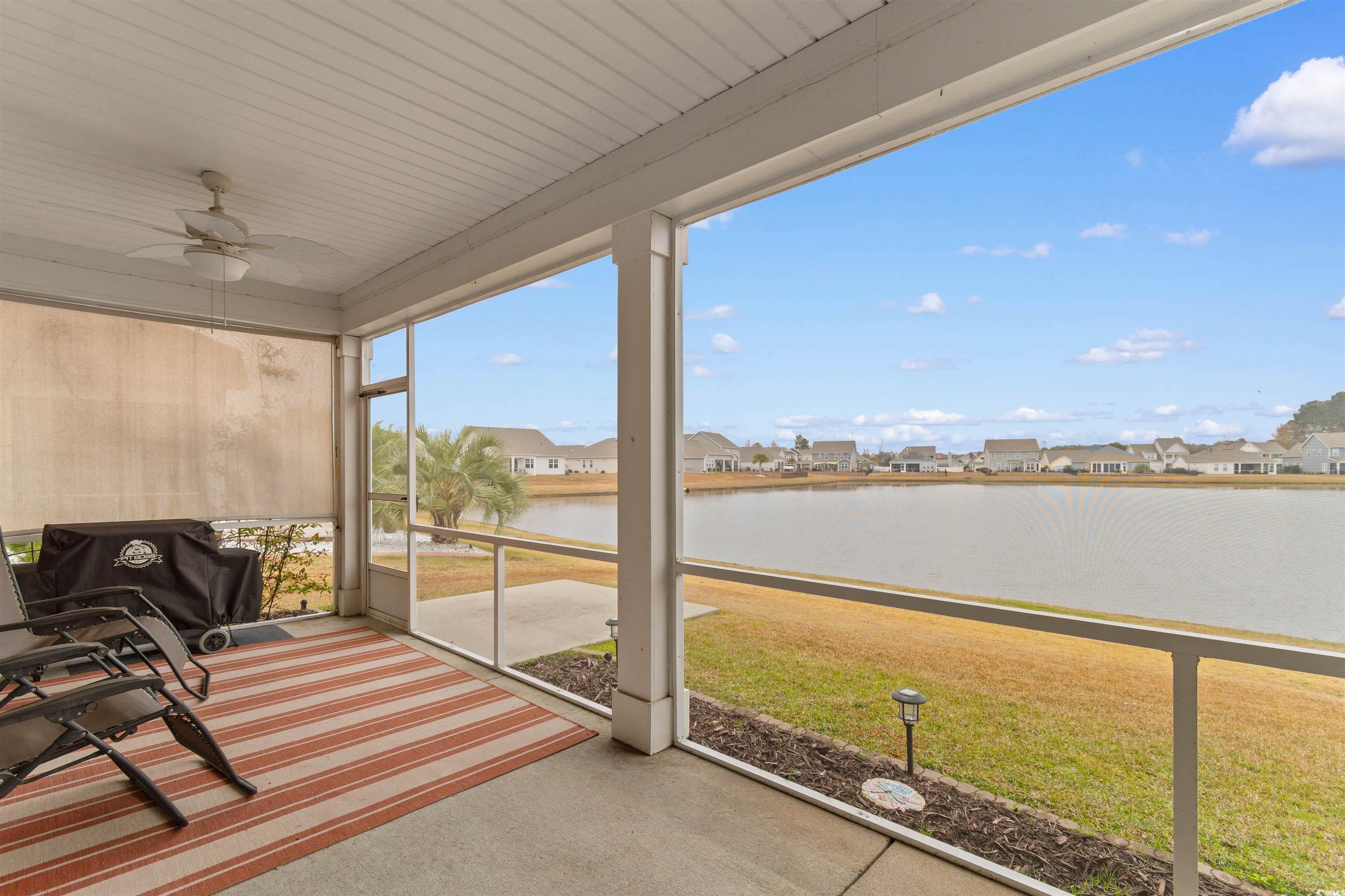 4842 Timberlake Drive Myrtle Beach, SC 29588 - Photo 31 of 38 Sunroom with a residential view, a ceiling fan, and a water view
