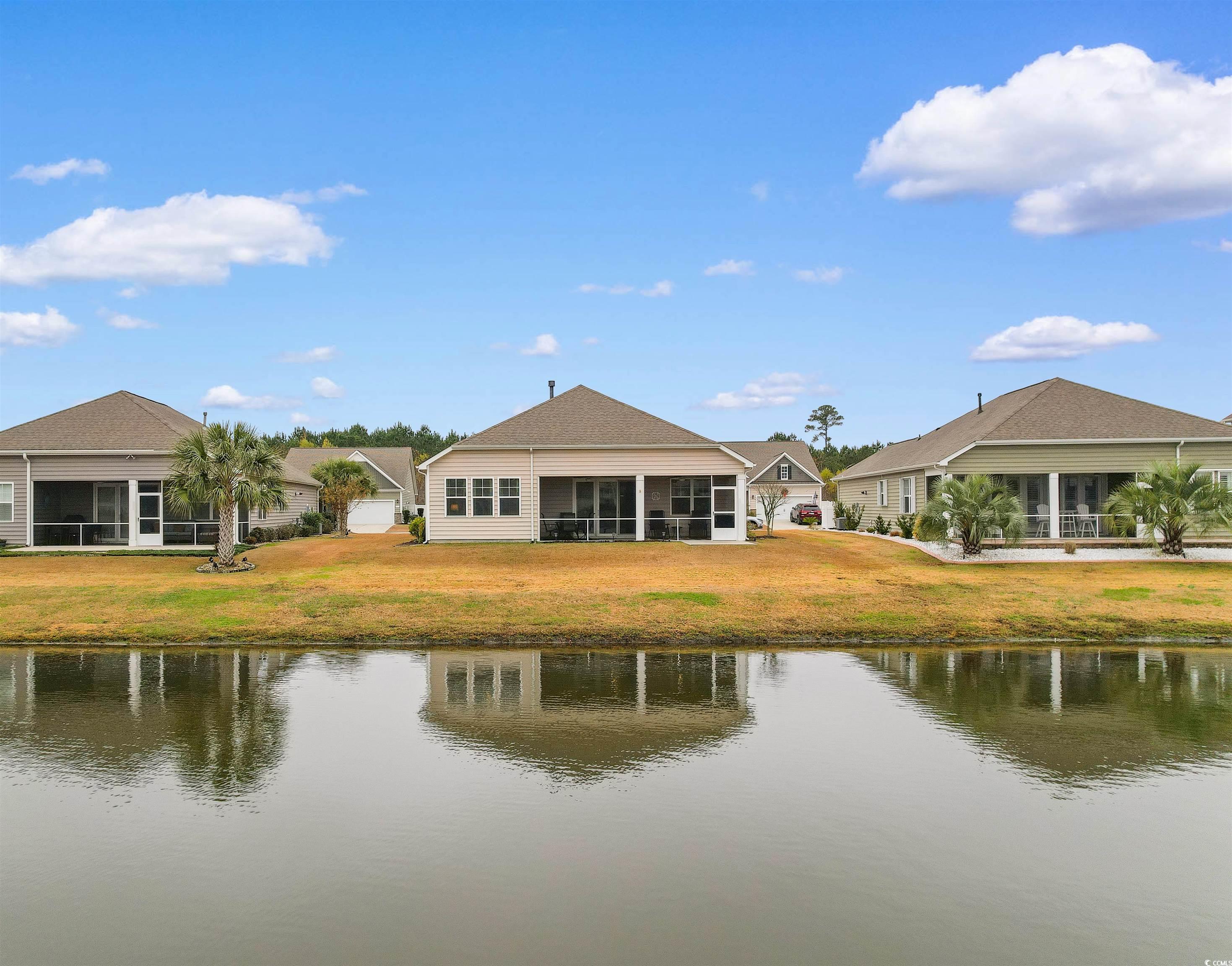 4842 Timberlake Drive Myrtle Beach, SC 29588 - Photo 6 of 38 Back of house with a sunroom, a water view, and a lawn