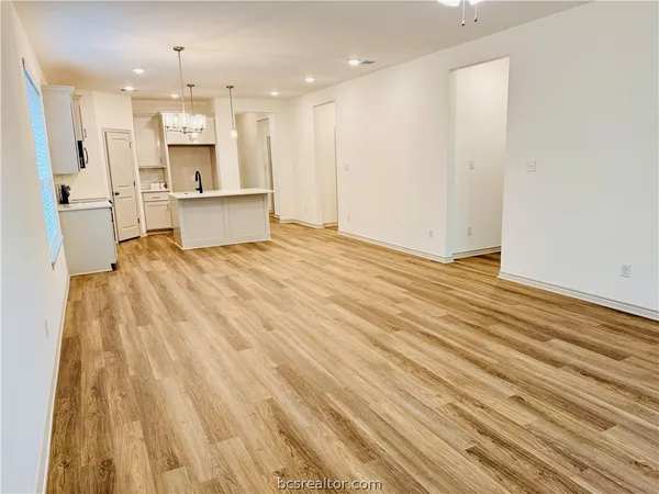 a view of kitchen with wooden floor and electronic appliances