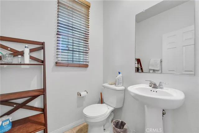 a bathroom with a sink toilet and a mirror