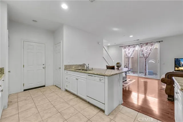 a kitchen with stainless steel appliances granite countertop a sink and a stove