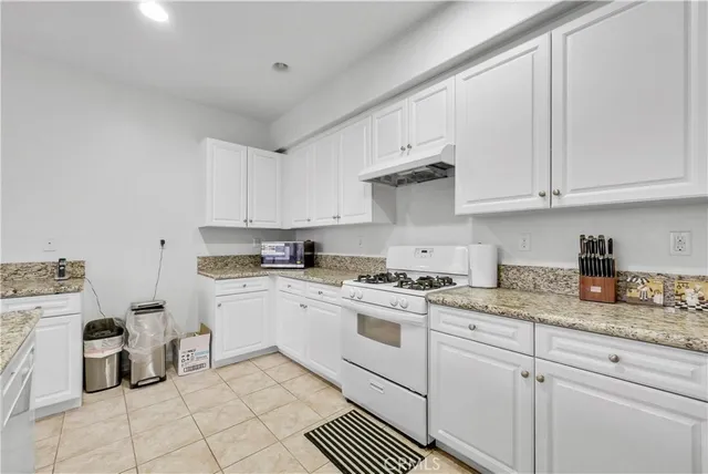 a bedroom with a bed couch and window