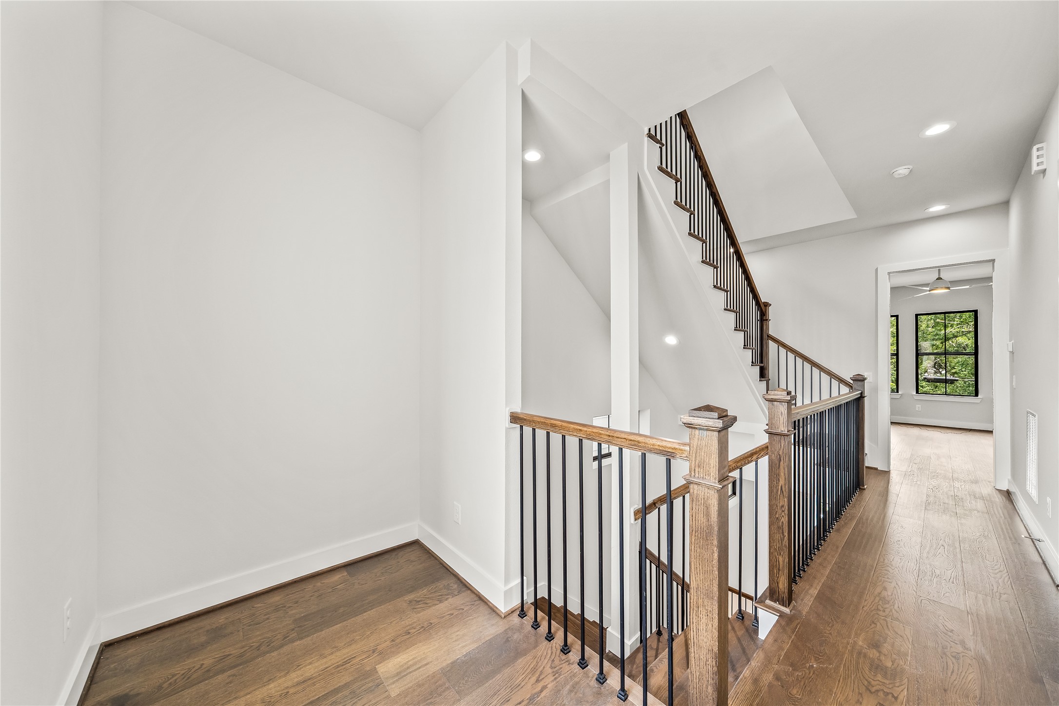 1705 Bologna Lane Houston, TX 77055 - Photo 18 of 43 a view of a hallway with wooden floor and staircase