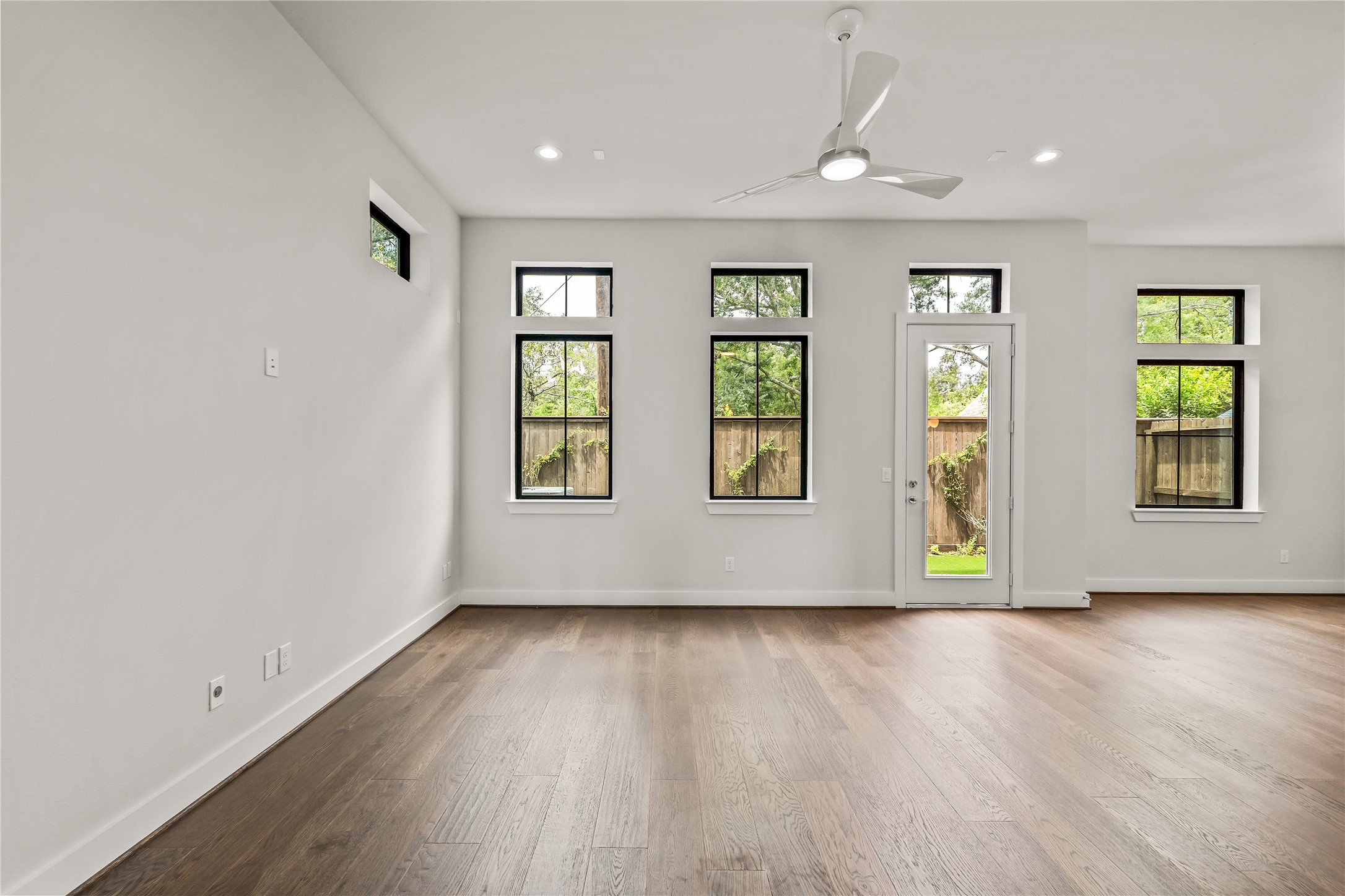 1705 Bologna Lane Houston, TX 77055 - Photo 19 of 43 an empty room with wooden floor and windows