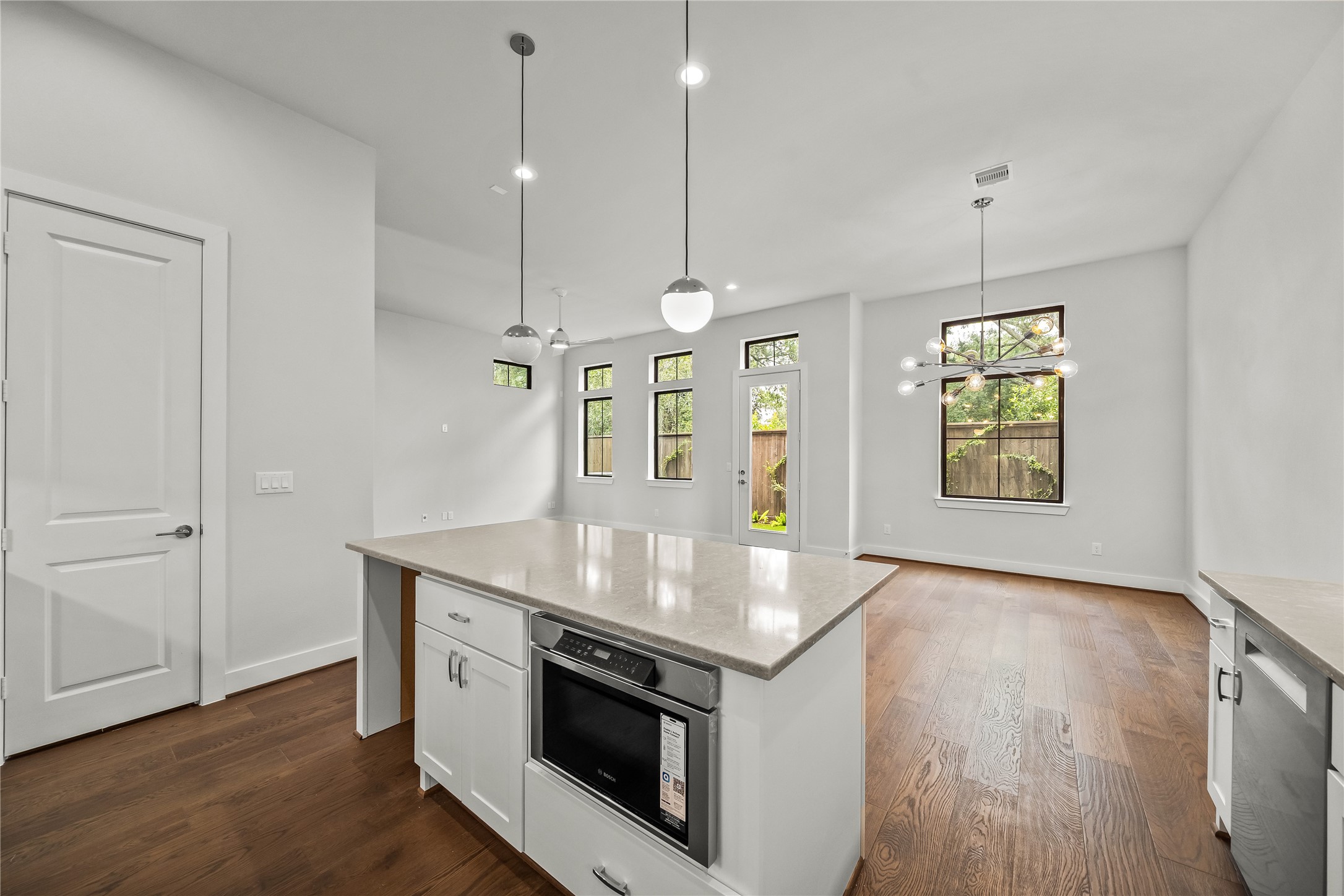 1705 Bologna Lane Houston, TX 77055 - Photo 5 of 43 a kitchen with stainless steel appliances granite countertop a stove a sink and a wooden floor